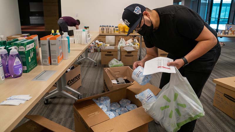 ServiceMax employees organizing essential household items for donation